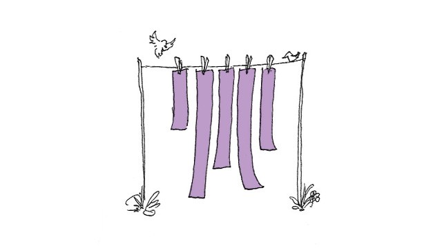 Long strips of paper hanging from a clothes line